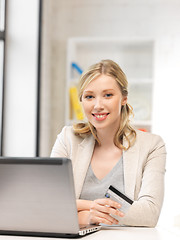 Image showing happy woman with laptop computer and credit card