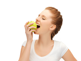 Image showing teenage girl biting a green apple