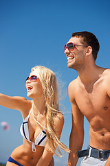 Image showing happy couple in sunglasses on the beach