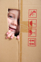 Image showing Child looking from box