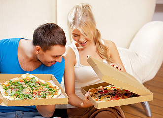 Image showing romantic couple eating pizza at home