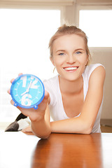 Image showing happy and smiling teenage girl with clock