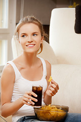 Image showing smiling teenage girl with chips and coke