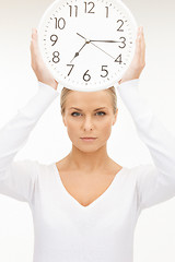 Image showing woman holding big clock