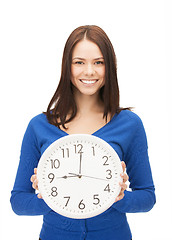 Image showing woman holding big clock