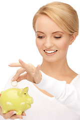 Image showing lovely woman with piggy bank and money