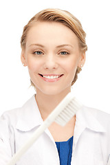 Image showing attractive female doctor with toothbrush