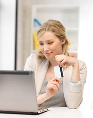 Image showing happy woman with laptop computer and credit card