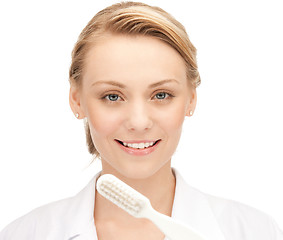 Image showing attractive female doctor with toothbrush