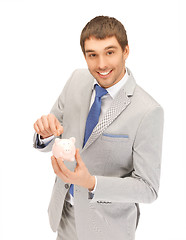 Image showing handsome man with piggy bank