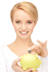 Image showing lovely woman with piggy bank and money