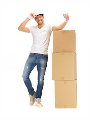 Image showing handsome builder with big boxes