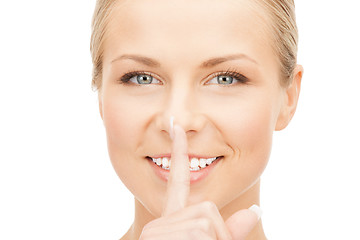 Image showing happy woman with finger on lips