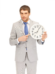 Image showing handsome man with clock