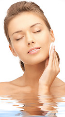 Image showing beautiful woman with cotton pad in water