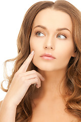 Image showing beautiful woman pointing to cheek