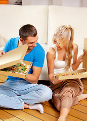 Image showing romantic couple eating pizza at home