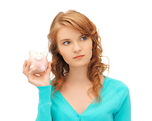 Image showing teenage girl with piggy bank
