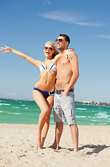 Image showing happy couple in sunglasses on the beach