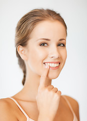 Image showing beautiful woman pointing to teeth