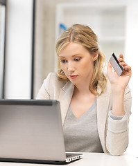 Image showing serious woman with laptop computer and credit card