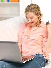 Image showing happy woman with laptop computer and credit card