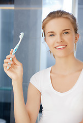 Image showing smiling teenage girl with toothbrush