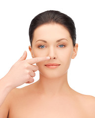 Image showing beautiful woman pointing to nose