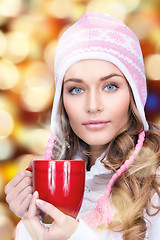 Image showing beautiful woman with red mug