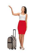 Image showing happy woman with suitcase greeting