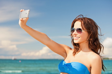 Image showing happy woman with phone on the beach