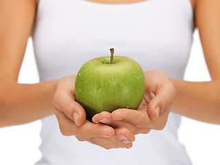 Image showing female hands with green apple