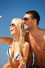 Image showing happy couple in sunglasses on the beach