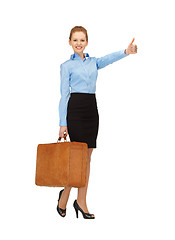 Image showing hitch-hiking woman with suitcase