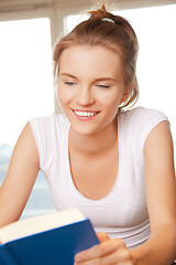 Image showing happy and smiling teenage girl with book