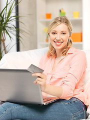 Image showing happy woman with laptop computer and credit card