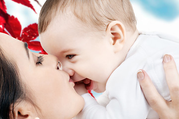 Image showing happy mother kissing baby boy