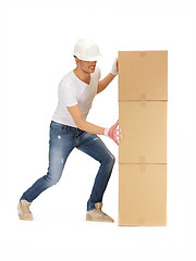 Image showing handsome builder with big boxes