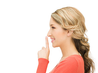 Image showing happy woman with finger on lips