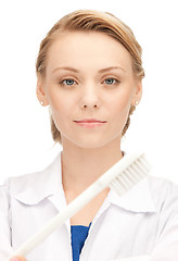 Image showing attractive female doctor with toothbrush