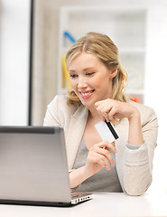 Image showing happy woman with laptop computer and credit card