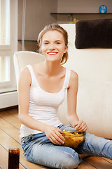 Image showing smiling teenage girl with chips and coke