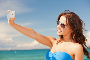 Image showing happy smiling woman using phone camera