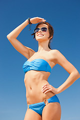 Image showing happy woman in sunglasses on the beach