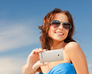 Image showing happy smiling woman using phone camera