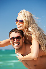 Image showing happy couple in sunglasses on the beach