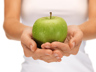 Image showing female hands with green apple