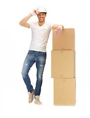 Image showing handsome builder with big boxes