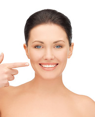 Image showing beautiful woman pointing to teeth