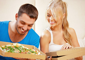 Image showing romantic couple eating pizza at home